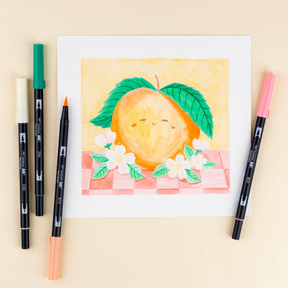 Art drawing using Dual Brush Pen Art Markers in Just Peachy colors with 6-Pack pens from a stationery store displayed around artwork.