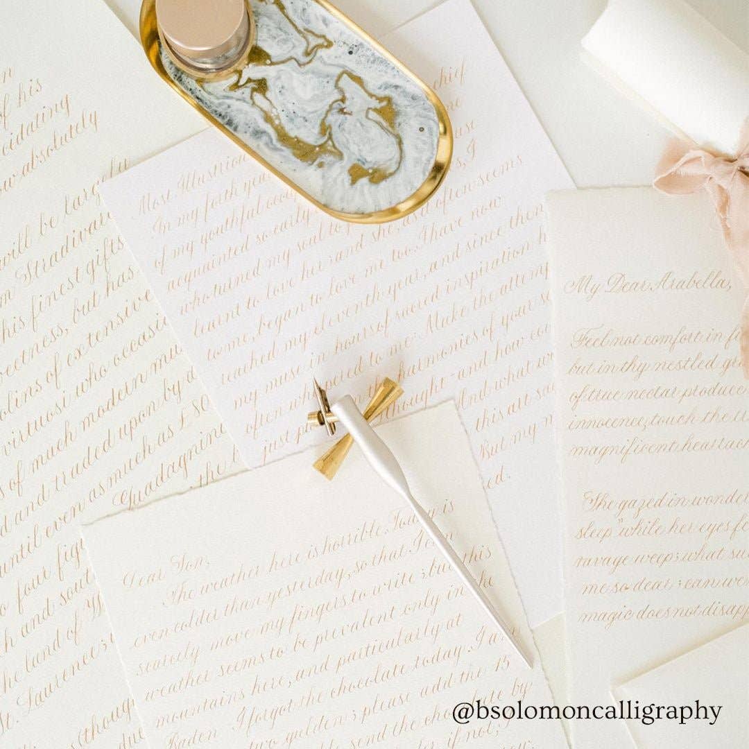 Flourish Calligraphy Pen set on handwritten letters, perfect for elegant writing from a stationery store