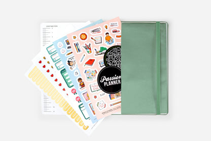 Alt Tag: Weekly 2025 Planner Year of the Snake Jade with stickers and pages, perfect for goal setting at a stationery store.