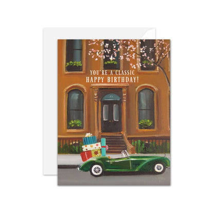 Vintage car birthday card with gifts, "You're A Classic" text, ideal for stationery stores. Blank inside, A2 size, eco-friendly paper.