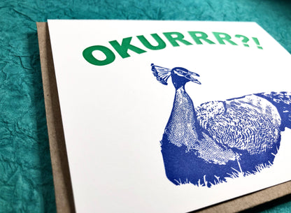 Greeting card featuring 'OKURRR?!' with a green and blue peacock, letterpress printed by Guttersnipe Press, available at stationery store.