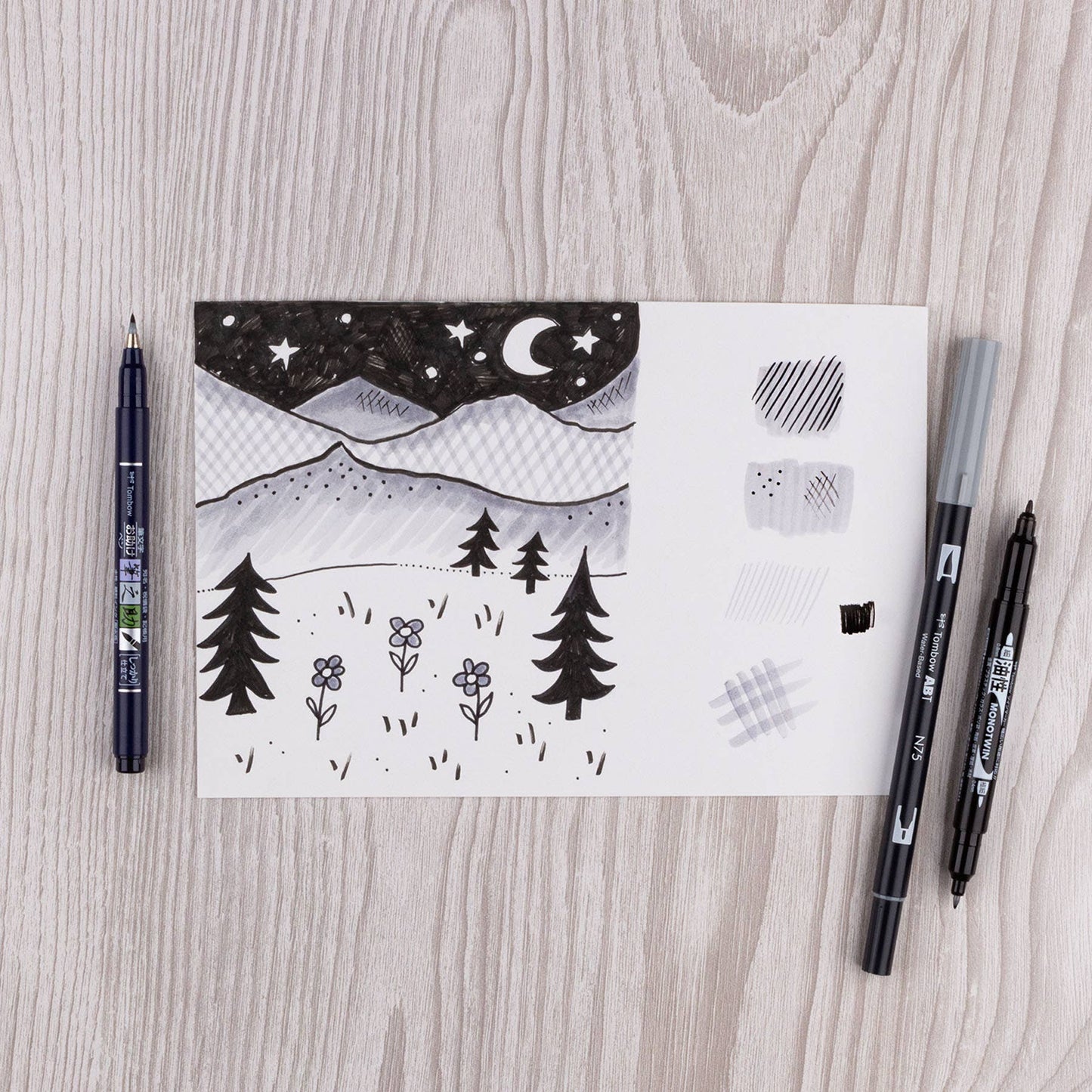 Tombow Drawing Set with sketch of night sky and trees, featuring dual brush pen and Fudenosuke, perfect for stationery store enthusiasts.