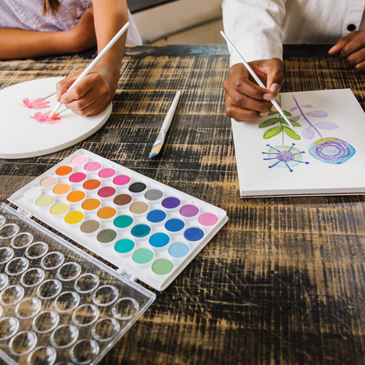 Artists painting with Chroma Blends Watercolor Paint Brushes set of 6, nylon brushes, in a stationery store setting.