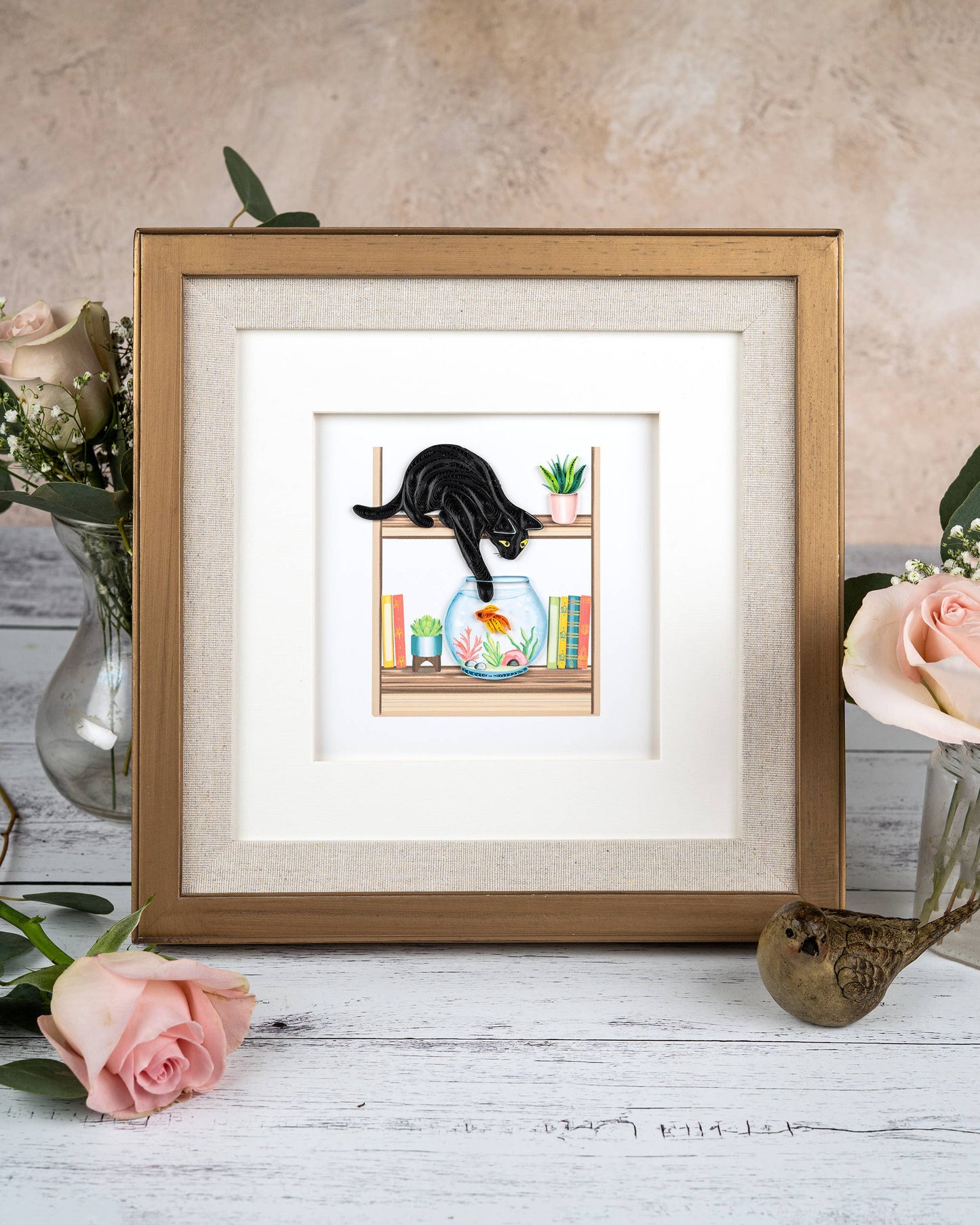 Quilled Mischievous Cat Greeting Card with black cat dipping paw in fish bowl, framed on wooden table. Perfect for stationery store collection.