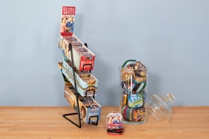 Display of Retiremints in a stationery store with reusable mint tins and a jar filled with colorful tins on a wooden counter.