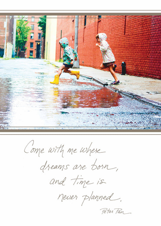 Children playing in rain with quote 'Come With Me Where Dreams Are Born, and Time Is Never Planned.' from Peter Pan, stationery store card.