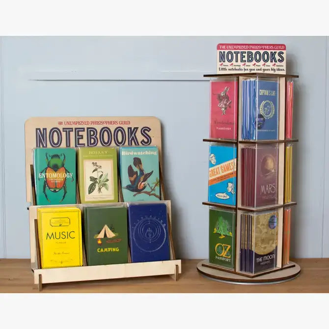 Display of Mini Masterpieces Notebooks at a stationery store, featuring vibrant covers, perfect for capturing ideas on the go.