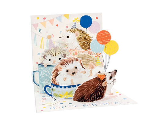 Colorful hedgehog pop-up birthday card with balloons, sold at a stationery store. Perfect for sending cheerful birthday wishes.