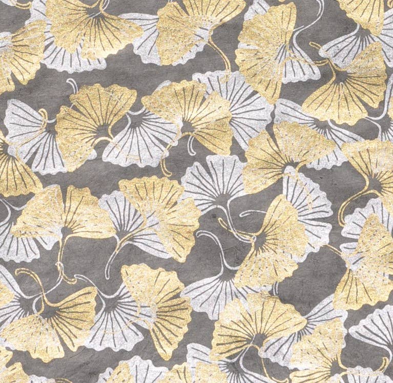 30x20 Ginkgo leaves decorative paper with gold and silver design, handmade in Kathmandu, available at stationery stores.