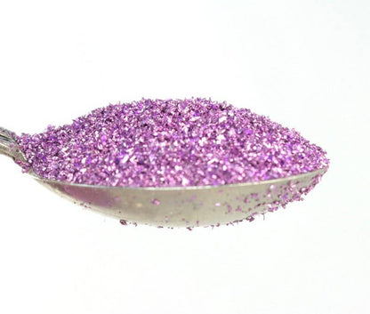 Lilac Sparkly German Glass Glitter, 90 grit, 25g, on spoon. Perfect for stationery store crafts and fine art projects.