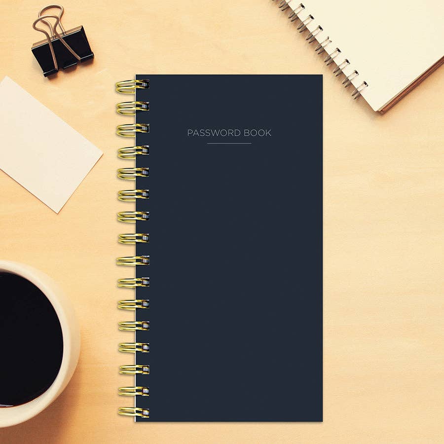 Black Spiral Password Book with durable cover on desk, ideal for organized stationery use in office or home. Sold at stationery stores.