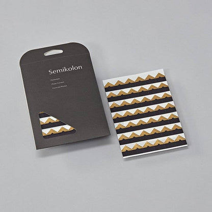 Self-adhesive photo corners in black, brown, cream, silver, and gold from Semikolon, available at stationery store.